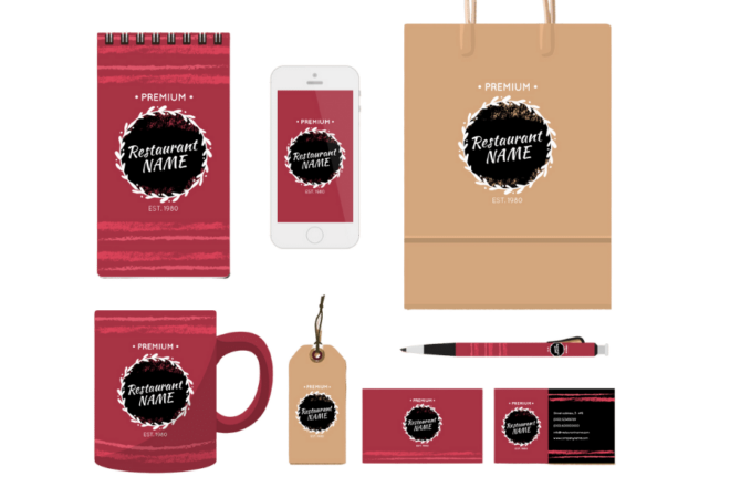 A Collection Of Branded Promotional Items Including A Notebook, Smartphone, Shopping Bag, Mug, Keychain, Pen, And Business Cards, All Featuring The Same Logo And Design For A Fictional Restaurant.